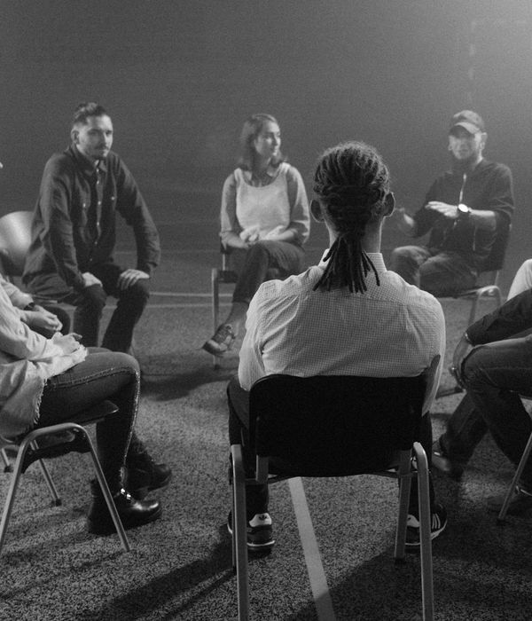 A diverse group of people sitting together peacefully after a grounding session.